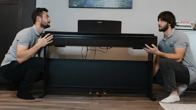 Movers carrying a sofa through a living room